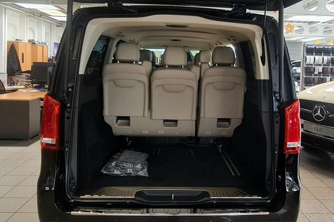 Exclusive green transfer - Meet Your Chauffeur: Name Tablet, Suits, and Calm Arrival